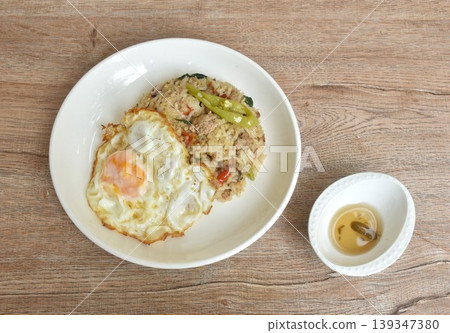 spicy fried mixed rice with chop pork basil topping egg in plate dipping chili fish sauce  139347380