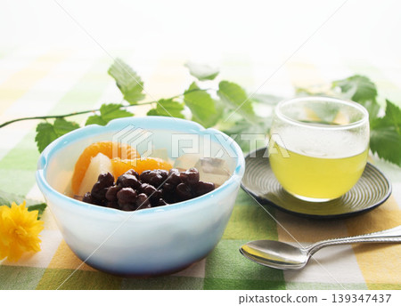 Anmitsu (Japanese sweets), red bean paste, and cold green tea. Anmitsu (Japanese sweets), red bean paste, and cold green tea. 139347437