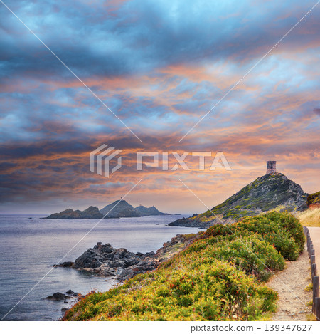 Amazing sunset over Torra di a Parata with Genoese Tower and Archipelago of Sanguinaires islands at background. Amazing sunset over Torra di a Parata with Genoese Tower and Archipelago of Sanguinaires islands at background. 139347627