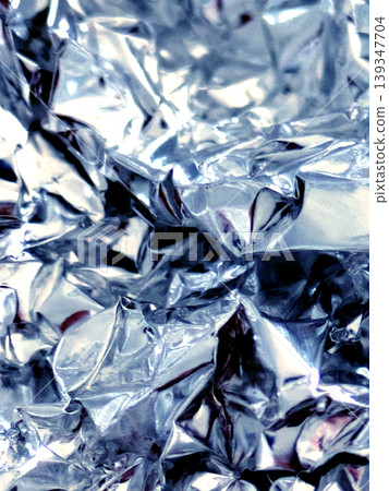 Shiny crumpled abstract silver foil close up background Shiny crumpled abstract silver foil close up background 139347704