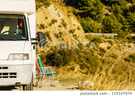 Rv motorhome with two chairs ready for outdoor living. Camping on nature Rv motorhome with two chairs ready for outdoor living. Camping on nature 139347974