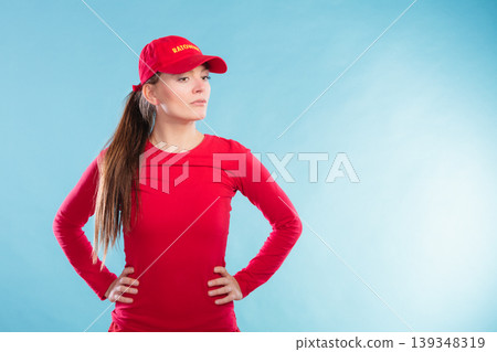 Portrait of lifeguard woman in red cap. Portrait of lifeguard woman in red cap. 139348319