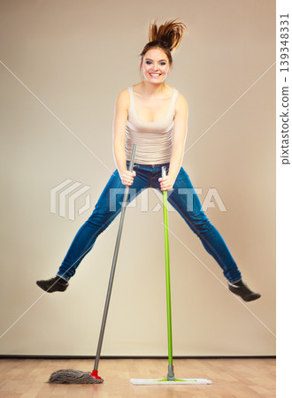 Funny cleaning woman mopping floor jumping 139348331