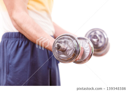 Man exercising with dumbbells lifting weights Man exercising with dumbbells lifting weights 139348386
