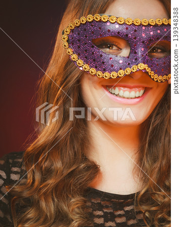 Closeup woman face with carnival violet mask on dark 139348388