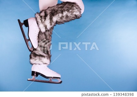Woman legs wearing ice skates fur socks, skating 139348398