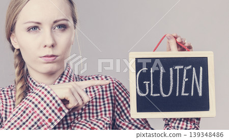 Woman holding board with gluten sign 139348486