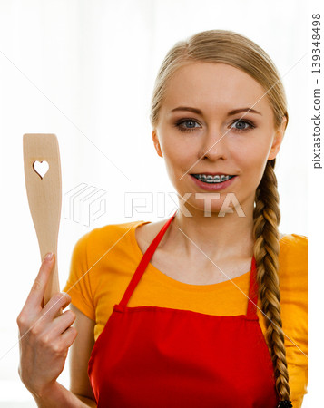 Woman holding wooden spatula with heart 139348498