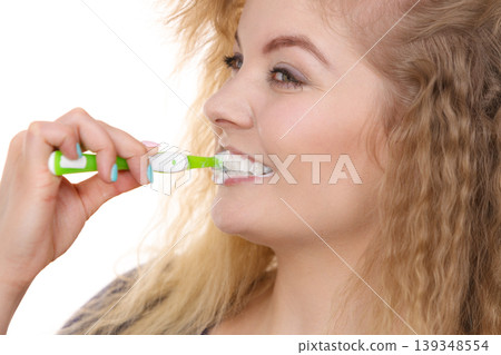 Woman brushing cleaning teeth Woman brushing cleaning teeth 139348554
