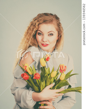 Pretty woman with red yellow tulips bunch Pretty woman with red yellow tulips bunch 139348562