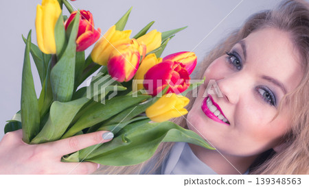 Pretty woman with red yellow tulips bunch Pretty woman with red yellow tulips bunch 139348563