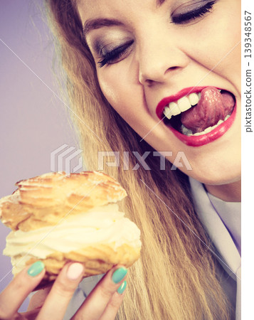 Funny woman holds cream puff cake Funny woman holds cream puff cake 139348567