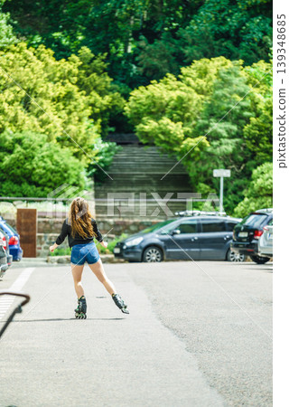 Young woman riding roller skates 139348685