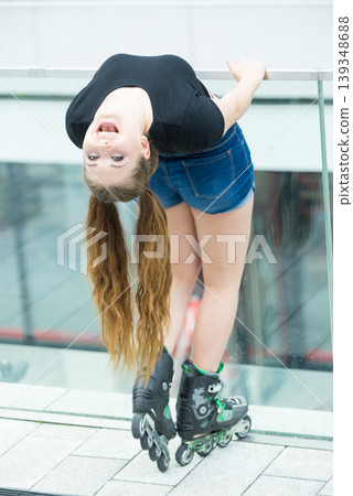 Young woman riding roller skates Young woman riding roller skates 139348688