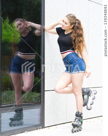 Young woman riding roller skates Young woman riding roller skates 139348691