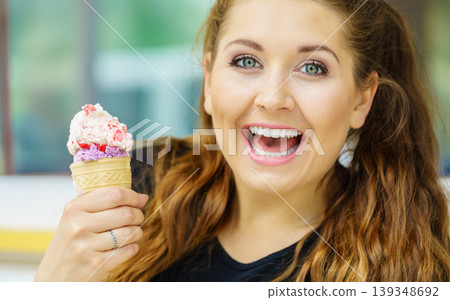 Young woman eating ice cream Young woman eating ice cream 139348692