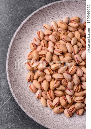 Salted pistachio nuts in shells as a healthy, high calorie food ingredient. Pistachio nuts 139349062