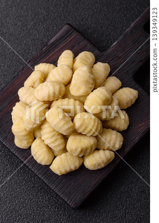 Raw homemade potato gnocchi, made with salt and spices, ready for lunch. Raw gnocchi Raw homemade potato gnocchi, made with salt and spices, ready for lunch. Raw gnocchi 139349123