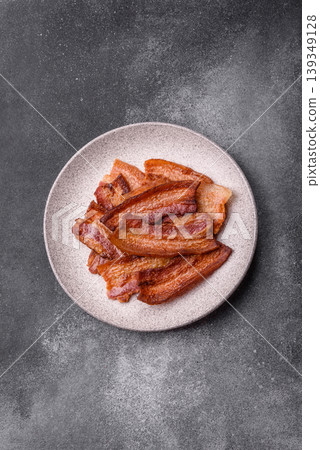 Fried fresh bacon slices with layers of meat or prosciutto prepared for breakfast. Fried bacon Fried fresh bacon slices with layers of meat or prosciutto prepared for breakfast. Fried bacon 139349128