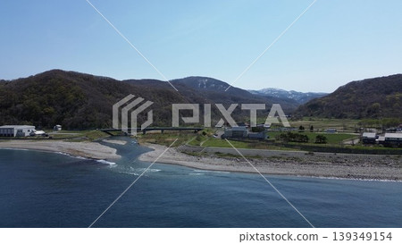 Aerial view of the natural scenery of the Chihaze River estuary and the Sea of Japan in Shimamaki Village, Hokkaido. Aerial view of the natural scenery of the Chihaze River estuary and the Sea of Japan in Shimamaki Village, Hokkaido. 139349154