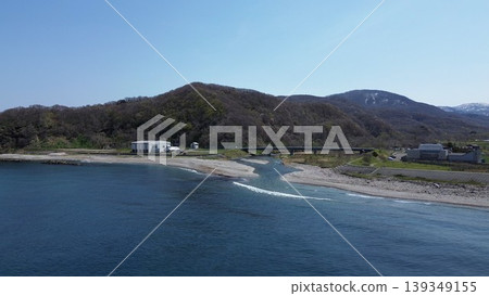 Aerial view of the natural scenery of the Chihaze River estuary and the Sea of Japan in Shimamaki Village, Hokkaido. Aerial view of the natural scenery of the Chihaze River estuary and the Sea of Japan in Shimamaki Village, Hokkaido. 139349155