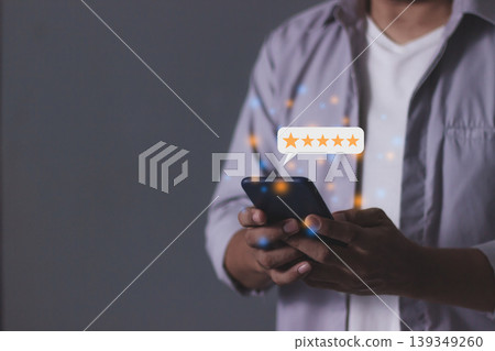 Customer Review, Young Man hand holding Smart Phone touching five star to review and give 5 stars with very good results in service, Good review 5 star rating choice feedback Customer Review, Young Man hand holding Smart Phone touching five star to review and give 5 stars with very good results in service, Good review 5 star rating choice feedback 139349260