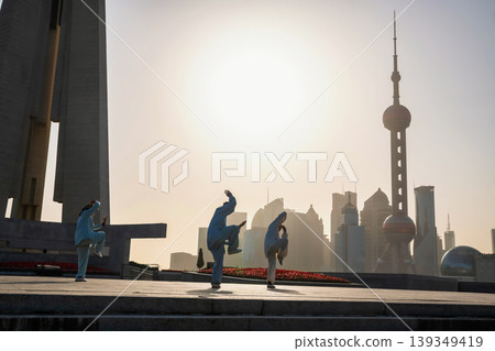 Chinese people  Tai Chi at People's tower at sunrise, Shanghai 139349419