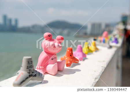 Pink art toy clay on wall by coastal at Huinnyeoul Village, Busan Pink art toy clay on wall by coastal at Huinnyeoul Village, Busan 139349447