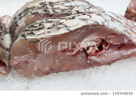 Close up of raw fish representing seafood processing and market ingredient preparation. Close up of raw fish representing seafood processing and market ingredient preparation. 139349650