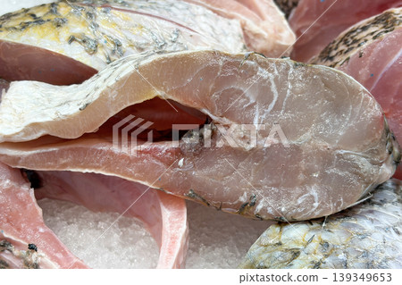 Close up of raw fish section representing seafood processing, fish market display and preparation. Close up of raw fish section representing seafood processing, fish market display and preparation. 139349653