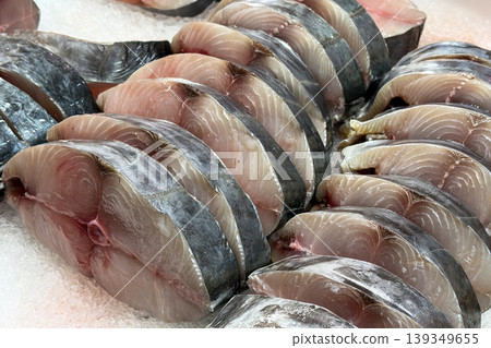 Fish steaks arranged in rows representing seafood retail display and fresh market cuts. Fish steaks arranged in rows representing seafood retail display and fresh market cuts. 139349655