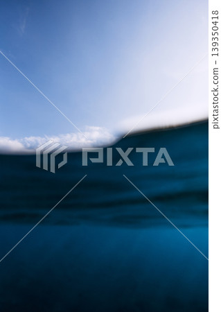 Split shot of sea wave and sky, minimal seascape with blue water and clouds, marine background Split shot of sea wave and sky, minimal seascape with blue water and clouds, marine background 139350418