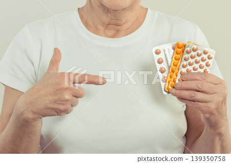 Elderly senior woman with tablets in hand Elderly senior woman with tablets in hand 139350758