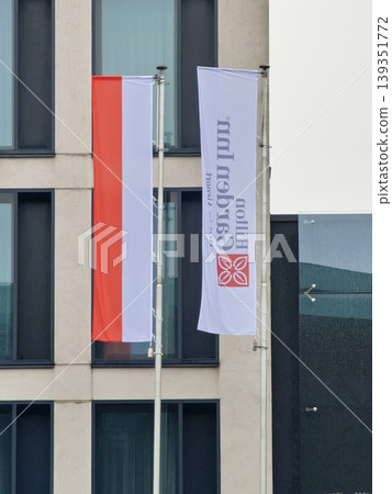 Balice, Krakow, Poland - March 27, 2026: Polish and hotel flags at the entrance to the Hilton Garden Inn Krakow Airport. Balice, Krakow, Poland - March 27, 2026: Polish and hotel flags at the entrance to the Hilton Garden Inn Krakow Airport. 139351772