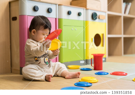 A Japanese baby boy playing in a colorful kids' room. 139351858