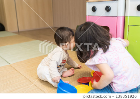 Japanese brother and sister playing in the apartment building's kids' room. Japanese brother and sister playing in the apartment building's kids' room. 139351926