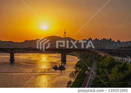 Seoul, South Korea - Apr. 24, 2026 : Beautiful golden hour over the busy urban highway with cars and city skyline 139351995