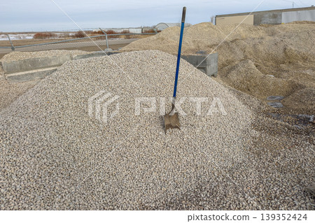 Gravel pile with shovel construction site Gravel pile with shovel construction site 139352424