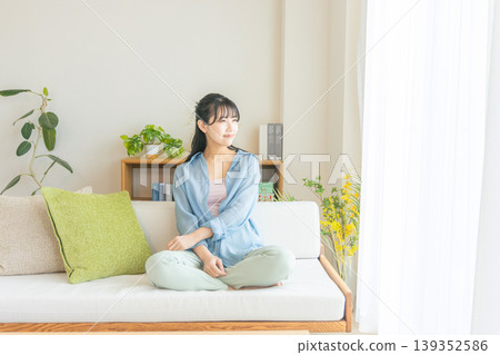 A young woman relaxing at home A young woman relaxing at home 139352586