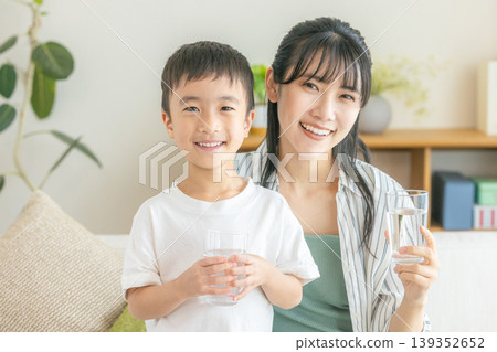 Family drinking water in the living room Family drinking water in the living room 139352652