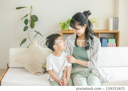 Parents and children relaxing in the living room Parents and children relaxing in the living room 139352655
