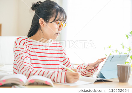 A woman studying qualifications A woman studying qualifications 139352664