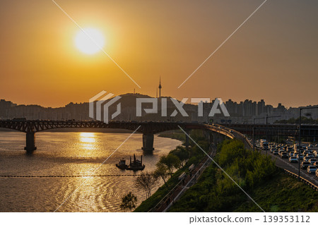 Seoul, South Korea - Jun. 25, 2023 : A refreshing glass of cafe latte at Jeongdong Observatory overlooking the historic palace and city skyline Seoul, South Korea - Jun. 25, 2023 : A refreshing glass of cafe latte at Jeongdong Observatory overlooking the historic palace and city skyline 139353112