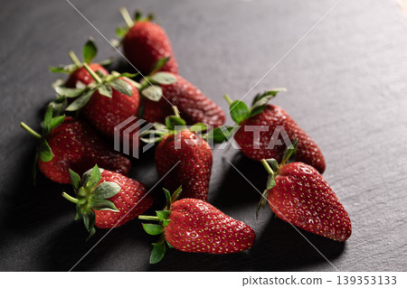Organic Strawberries on Dark Granite Background. Organic Strawberries on Dark Granite Background. 139353133