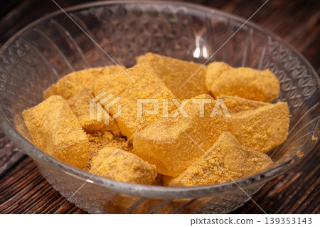 Close-up photo of kinako mochi placed against a wooden background. Close-up photo of kinako mochi placed against a wooden background. 139353143
