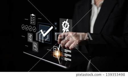 Business professional interacting with holographic technology and digital checklists for process management and productivity enhancement strategies Gantry 139353498
