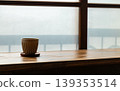 Wooden lattice window view, frosted glass, ceramic coffee cup and clear water glass. 139353514