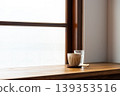 Wooden lattice window view, frosted glass, ceramic coffee cup and clear water glass. 139353516