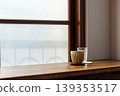 Wooden lattice window view, frosted glass, ceramic coffee cup and clear water glass. 139353517