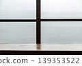 A Japanese-style coffee shop with a wooden bar counter by frosted glass windows and a blank still-life background. 139353522